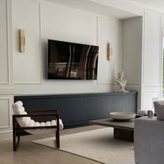 a large flat screen tv mounted to the side of a wall in a living room