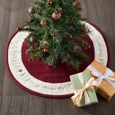 a small christmas tree sitting on top of a red rug