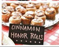 a table topped with lots of pastries on top of a red and white checkered table cloth