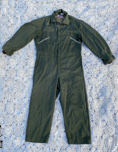 "This listing is for a pair of vintage 1970s 1980s green insulated coveralls by Walls. These coveralls are so great and are in good vintage condition! Coveralls do show wear including paints marks, stray marks, small holes and runs in fabric. These are all consistent with wear and use and give them that great distressed look! Coveralls are a green khaki/olive drab and are insulated with a different shade of green colored fabric. These are the Blizzard-Pruf style coveralls. There are a few differ Military Style Cotton Overalls, Green Long Sleeve Cotton Jumpsuits And Rompers, Green Cotton Long Sleeve Jumpsuits And Rompers, Green Long Sleeve Cotton Jumpsuit, Green Cotton Long Sleeve Jumpsuit, Green Cotton Utility Overalls, Green Utility Overalls For Workwear, Military Style Long Sleeve Cotton Jumpsuit, Military Style Long Sleeve Cotton Jumpsuits And Rompers