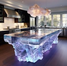 a kitchen with an island made out of ice and frosty glass in the center