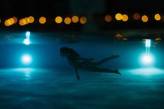 a woman floating in the water at night