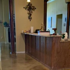 an empty kitchen with marble floors and wooden cabinets