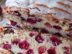 two slices of cake with white frosting and cranberry toppings on a plate