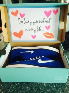 an open shoe box with some writing on the inside and blue shoes in the bottom