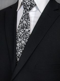 "Elegant necktie for the big day. Makes the perfect gift for the father of the bride. Features a black background with white floral pattern. Pocket Square available upon request pending available of fabric cost $10.00 Convo me to check availability. Expertly hand-made from 100% cotton you can select your length from 57\" to 71\" (Great for taller Men). Width is standard 3.5\" as shown here or skinny 2.5\". If you require a custom length or width, please contact us. 2.5\" x 48\" Child size availa Floral Wedding Tie, Winter Bridesmaid, Winter Bridesmaids, Winter Bridesmaid Dresses, Make A Tie, Floral Necktie, Flower Tie, Wedding Tie, Tie Pattern