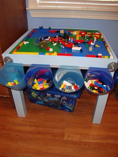 a table with legos and bowls on it in the middle of a living room