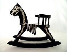 a rocking horse with skeleton paint on it