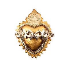 an ornate gold and silver brooch with two birds on it's back side