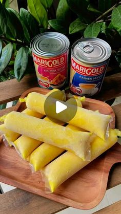 pineapple slices on a cutting board next to cans of margold and canned mustard