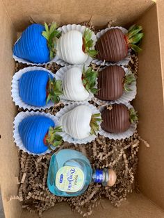 chocolate covered strawberries in a cardboard box with blue and white decorations on top, including milk