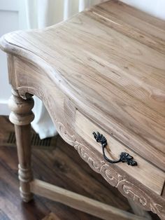 a wooden table with an ornate handle on it