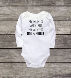 a long sleeved bodysuit that says, my mom is taken but my adult is hot & single