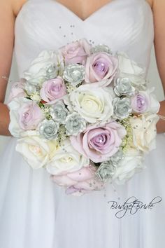 a bride holding a wedding bouquet in her hands