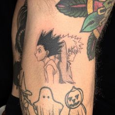 a man's arm with tattoos on it, including an image of a boy and ghost