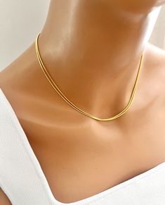 Minimal gold snake chain choker necklace basic yet stylish: it can be layered with other chokers or necklaces. -------------------- DETAILS ・1 mm 24K gold plated snake chain ------------------- SIZE ・Available in 4 sizes 12"- 14" ( 12 inches + adjustable 2 inch extender) 14" -16 "( 14 inches + adjustable 2 inch extender) 16"- 18"( 16 inches + adjustable 2 inch extender) 18"-20"(18 inches + adjustable 2 inch extender) ・It closes with lobster clasp. ------------------- JEWELRY CARE ・Plated brass i Gold Minimalist Snake Chain Choker, Minimalist Snake Chain Clavicle Choker Necklace, Gold Minimalist Snake Chain Choker Necklace, Minimalist Snake Chain Clavicle Choker, Gold Minimalist Double Chain Snake Necklace, Gold Double Chain Snake Necklace In Minimalist Style, Minimalist Double Chain Herringbone Necklace, Minimalist Herringbone Choker With Clavicle Chain, Dainty Chain Necklace