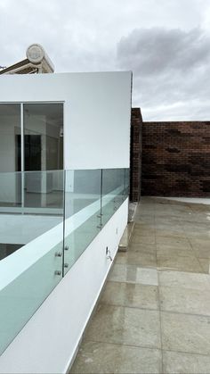 a white building with glass balconies on the outside