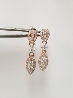 "Thanks for shopping our vintage estate store. We tend to sell well below wholesale and truly hope you enjoy all of our items. Many of the items are one of a kind, so please enjoy scrolling through the pictures and hopefully something will catch your eye. Black spots are from camera or reflections. Nice new 10k rose white gold .50ct diamond dangle earrings. There are 66 diamonds in the pair. Just stunning. Length: 7/8\" Width: 3mm 1/8\" Weight: 2.39 grams Clarity: SI2 Color: H Marked 10k, some t Rose Gold Dangle Diamond Earrings For Anniversary, Rose Gold Diamond Drop Earrings For Anniversary, Anniversary Rose Gold Diamond Drop Earrings, Beach Rings, Diamond Dangle Earrings, Diamond Rings Bands, Earrings Stud, Cz Diamond, Round Earrings