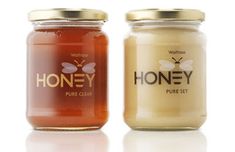 two jars of honey on a white background