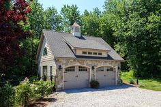 a two car garage in the middle of a driveway