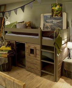 a bunk bed sitting on top of a wooden floor