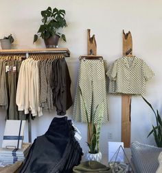 clothing boutique design with items on a table and on racks. Includes plants and wood paneling. Antique Booth Ideas, Denver City, Boutique Design, Boutique Shop, Clothing Boutique, Wardrobe Rack, Boutique Clothing, Shop Design, Boutique