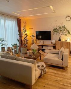 a living room filled with furniture and a flat screen tv mounted to the side of a wall