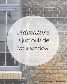 a brick wall with the words adventure is just outside your window in front of it