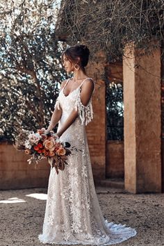 a woman in a wedding dress holding a bouquet