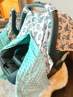 two baby carseats sitting next to each other on the floor