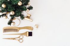 gold scissors, combs and christmas ornaments on a white background