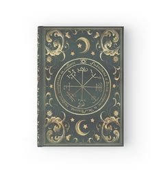 a book with an image of the moon and stars on it, in gold foil