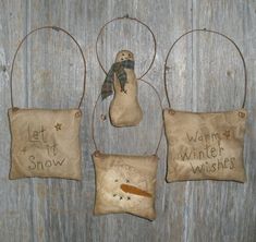 three ornaments hanging on the side of a wooden wall