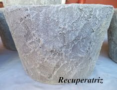 three cement pots sitting on top of a table