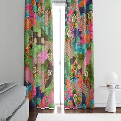 the curtains in this room are decorated with colorful flowers