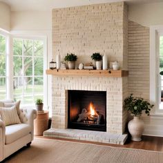 a living room filled with furniture and a fire place in the middle of a fireplace