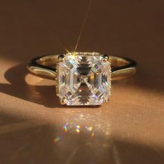 a diamond ring sitting on top of a table