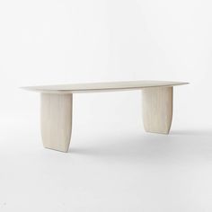 a white table with curved legs on a plain surface in front of a white background