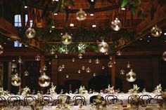 the tables are set with white tablecloths and centerpieces, surrounded by hanging bubbles