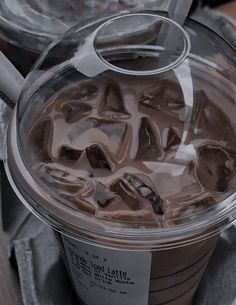 a plastic cup filled with ice cream and chocolate