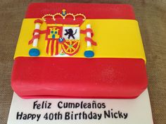 a birthday cake with the flag of spain on it's side and name written in spanish