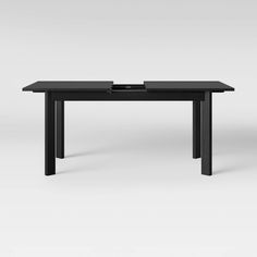 a black table sitting on top of a white floor