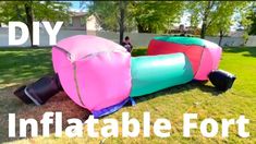 an inflatable fort is sitting on the grass and it's made out of plastic