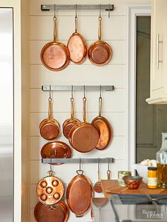 pots and pans are hanging on the wall