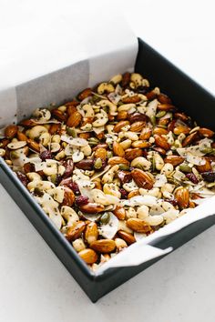 nuts and seeds are mixed together in a baking dish