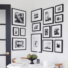 a dining room table with pictures on the wall