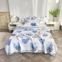 a bed with blue and white hearts on it