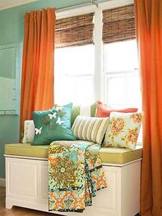 a living room filled with lots of furniture and colorful pillows on top of it's windowsill