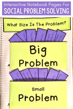 a poster with the words big problem and small problem on it, in front of a notebook