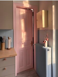 a pink door and radiator in a room